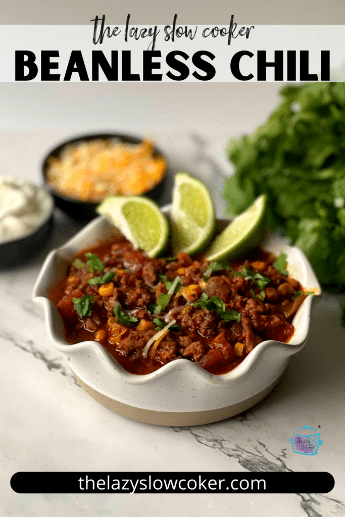 pinterest pin of a beanless bowl of chili with lime wedges