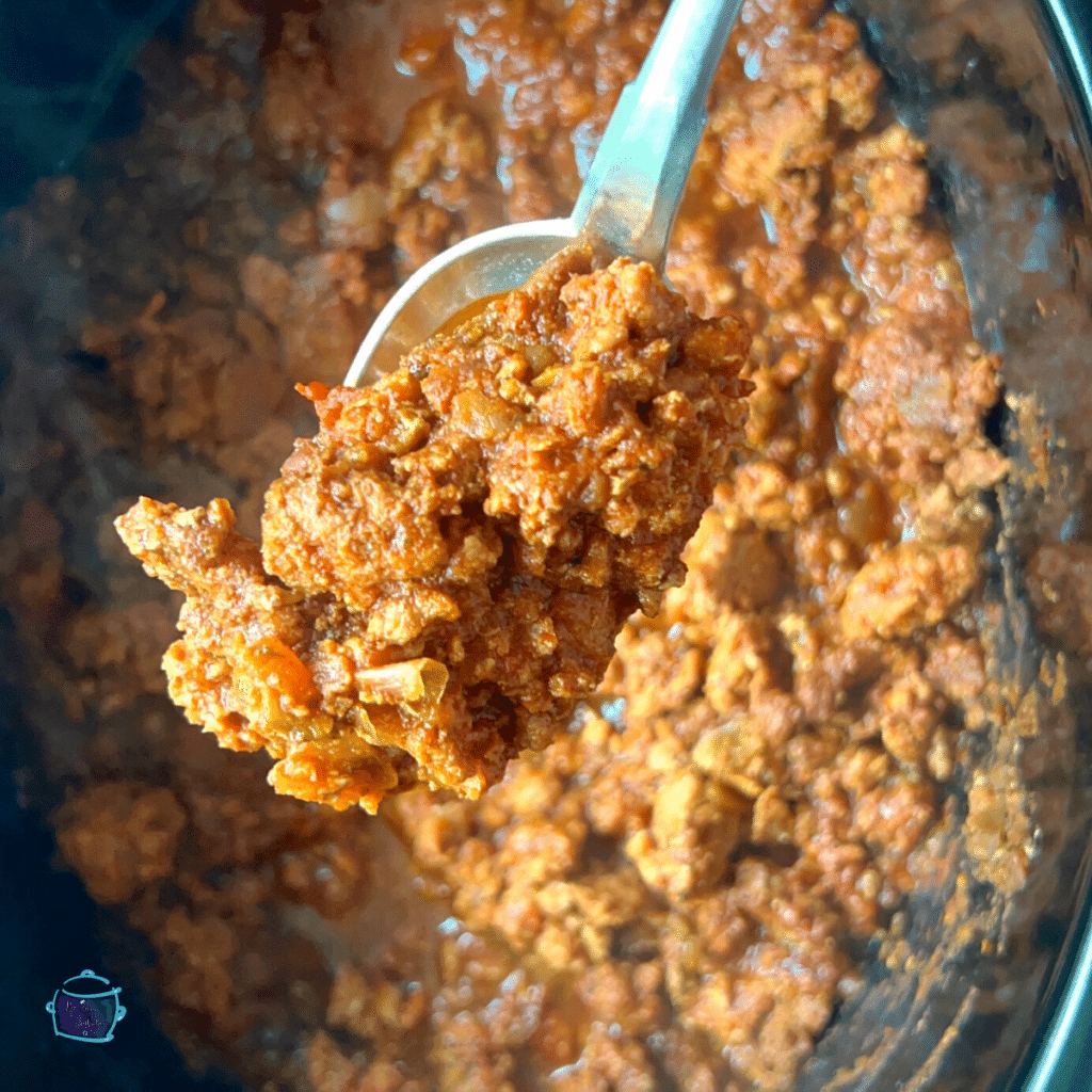 crockpot chili without beans on a spoon