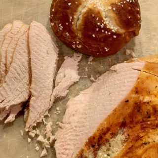 Sliced turkey breast with pretzel roll