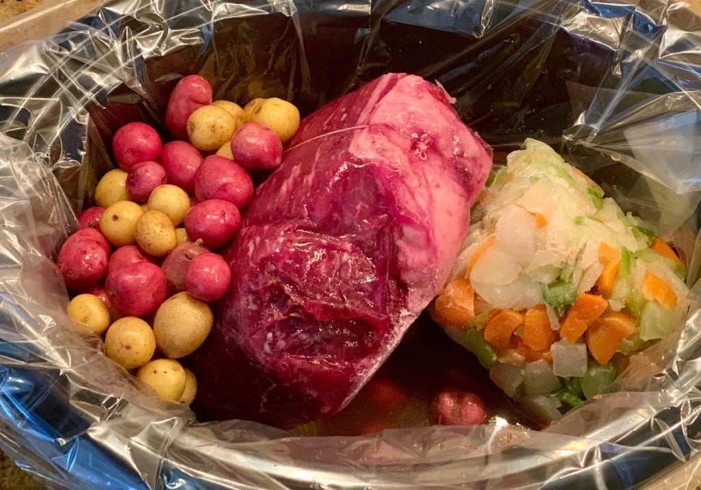 Potatoes, roast and vegetables in pot before cooking