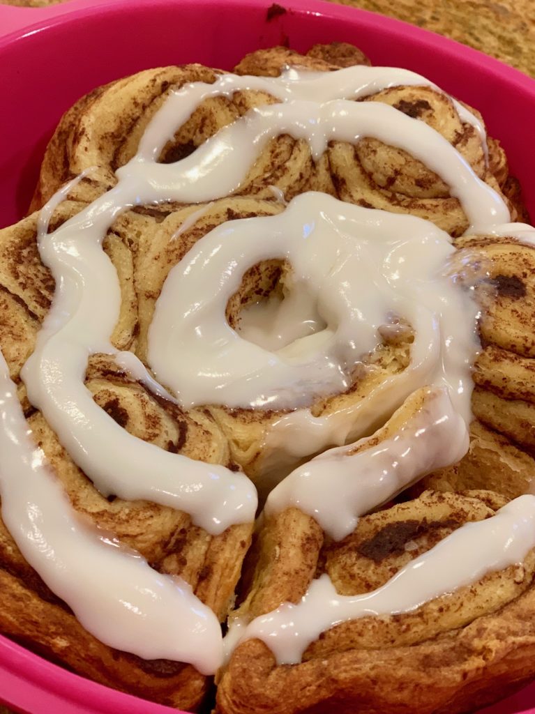 cinnamon bun roll apart with cream cheese icing