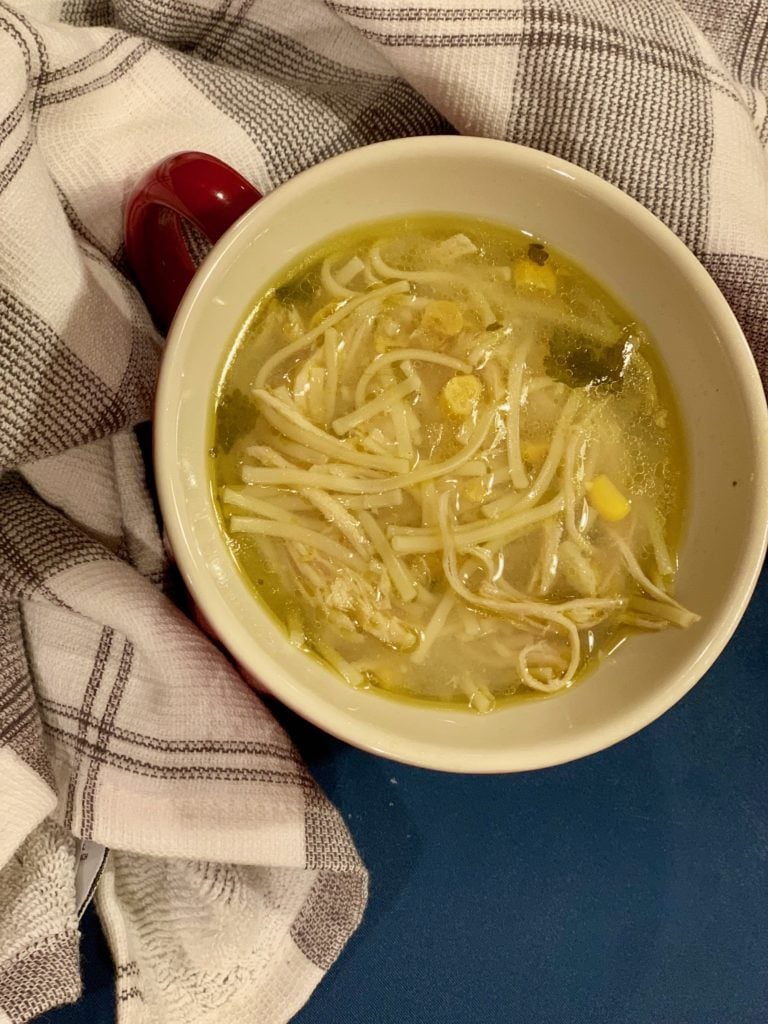 a bowl of slow cooked chicken and corn soup