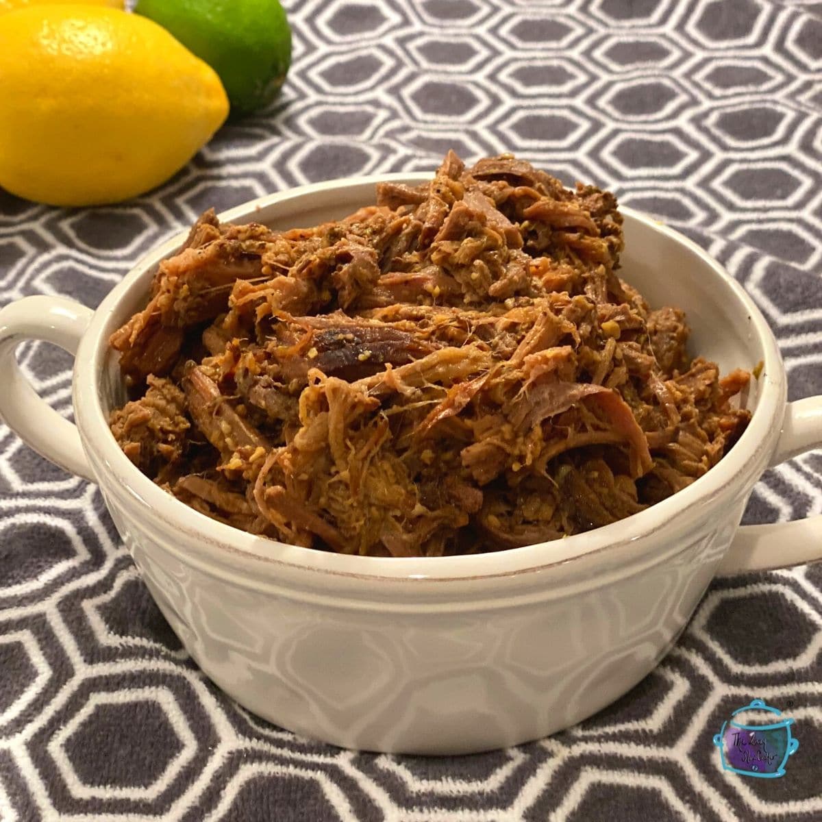 a white bowl filled with shredded beef barbacoa