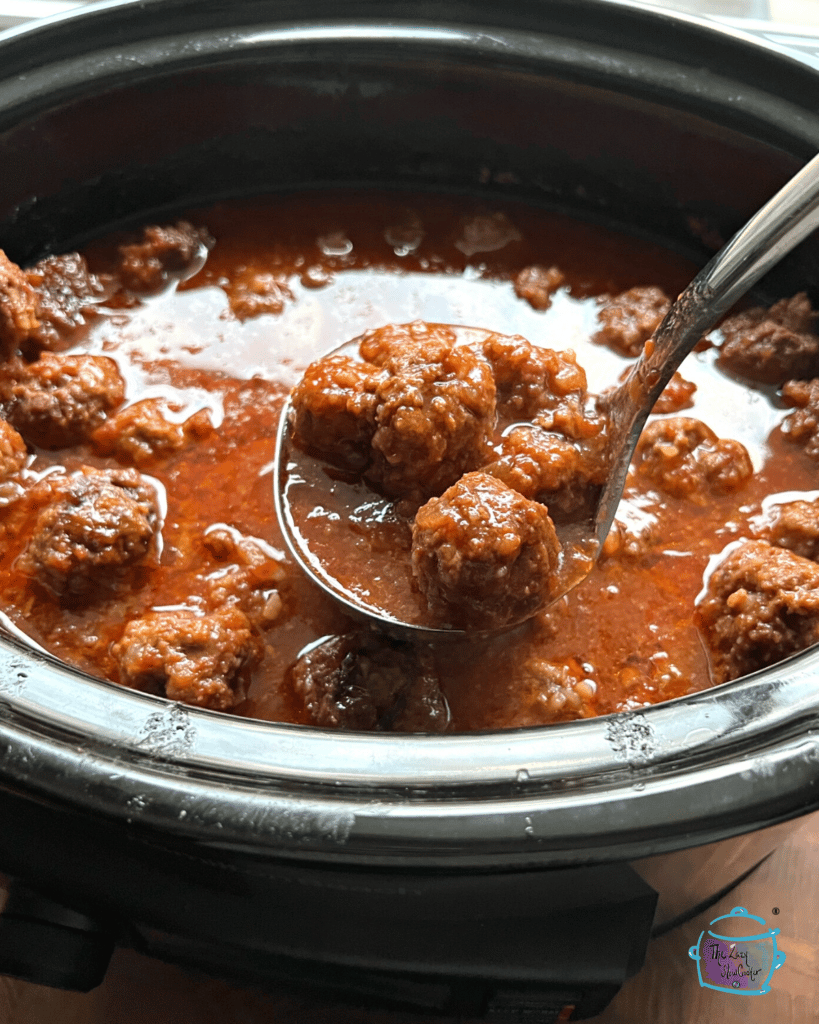 sweet and slow meatballs in slow cooker after cooking. some on a ladel.