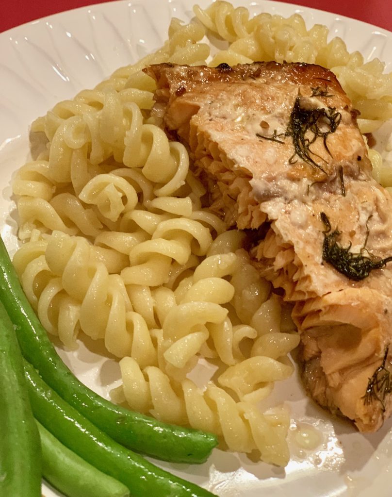 Salmon on plate with pasta and green beans