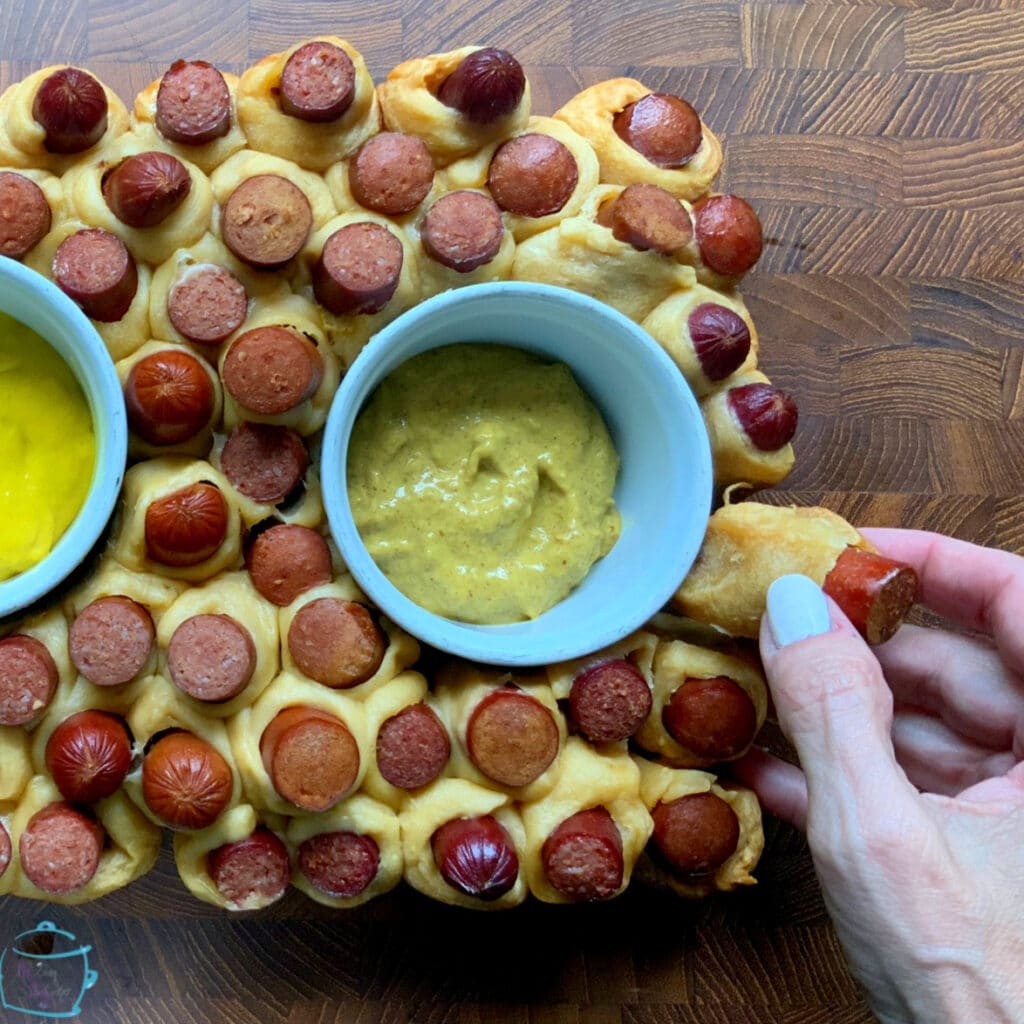 a rectangular hot dog pull apart with a piece being pulled off of the edge
