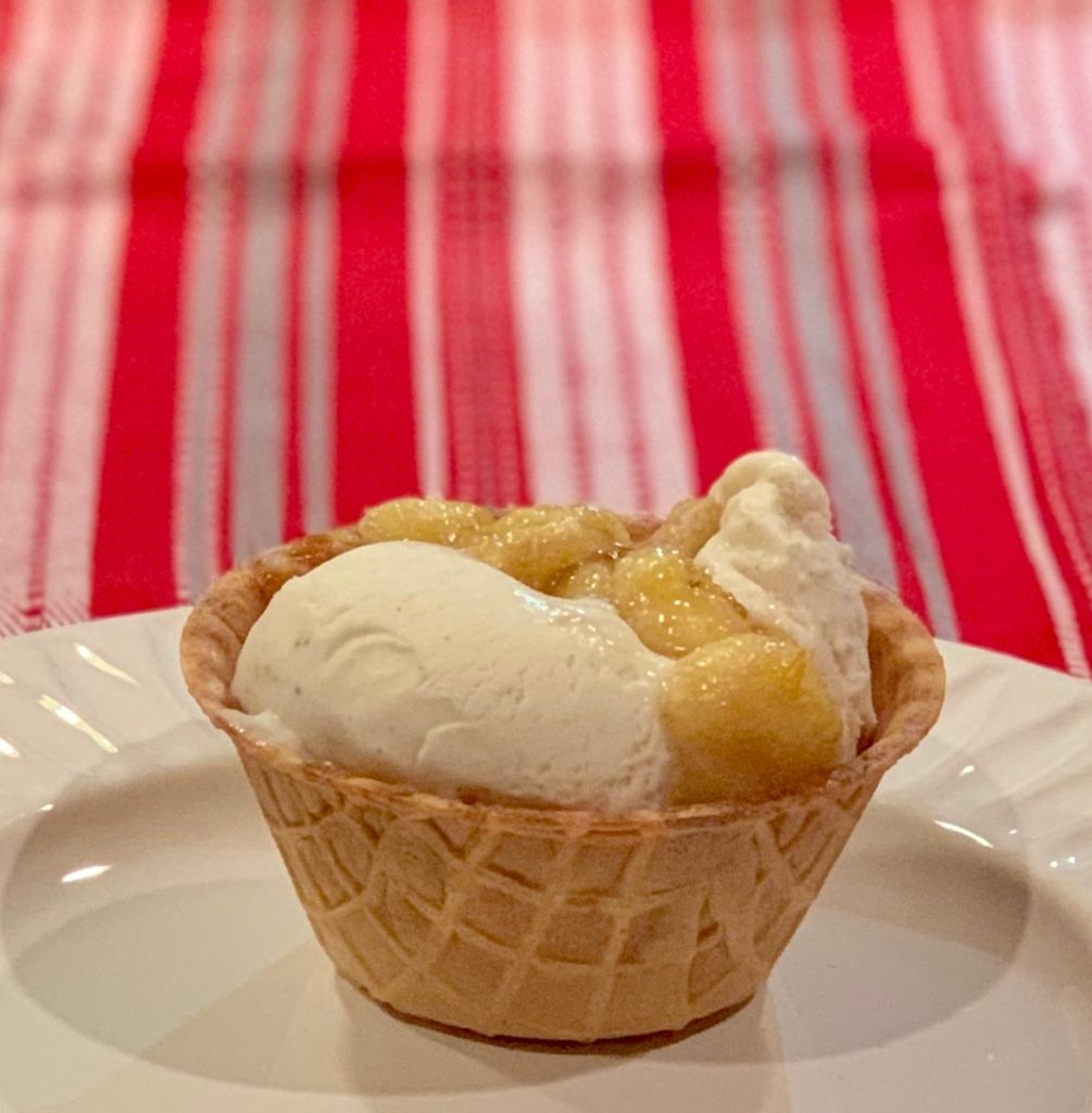 Vanilla ice cream in a waffle cup with banana topping