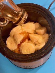 Adding maple syrup to bananas