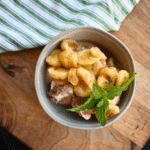 slow cooker banana topping on top of a bowl full of ice cream