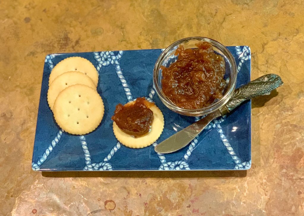 Apple butter on a tray with crackers