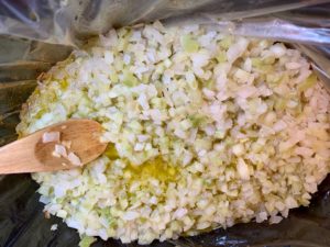celery and onion softening in slow cooker in oil