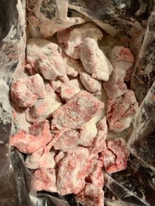 beef cubes coated with flour in slow cooker