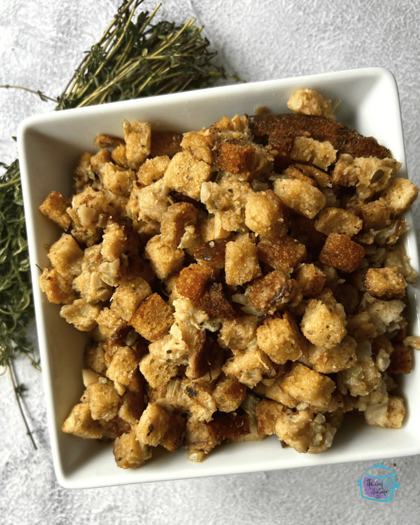 A square bowl filled with crockpot stuffing