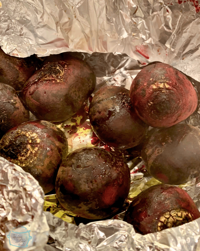 beets in oil and salt about to be wrapped up in a foil package prior to slow cooking