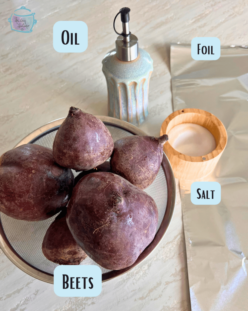 fresh beets in a bowl with an oil dispenser, foil and salt cellar