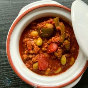 Terracotta bowl filled with chili with edamame and ground turkey