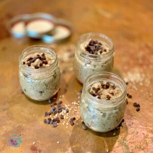 Three jars filled with cookie dough oatmeal topped with chocolate chips