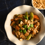 Thai peanut chicken with noodles made in a crockpot in a round white bowl