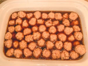 raw chicken meatballs in teriyaki sauce waiting to be slow cooked