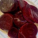 Roasted beets sliced on a white plate