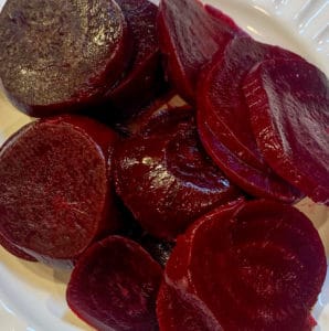 Roasted beets sliced on a white plate