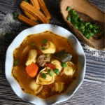 turkey sausage tortellini soup in a white bowl