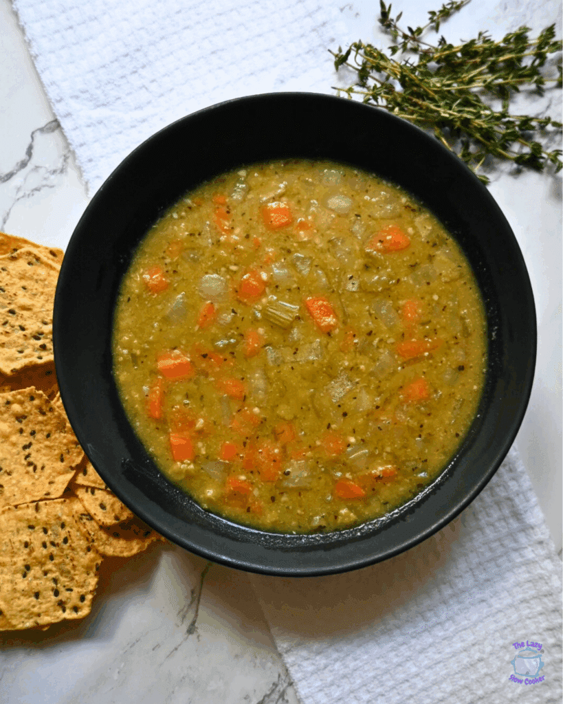 a black round bowl containing slow cooker vegan pea soup