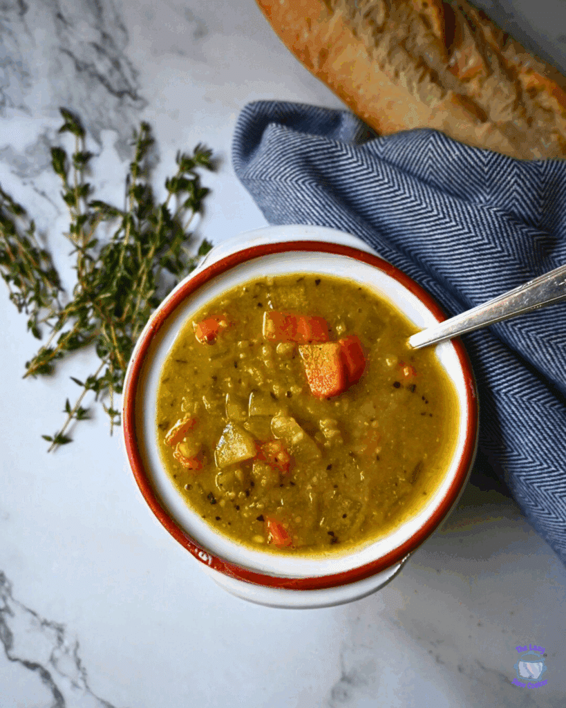 a round bowl with a spoon containing slow cooker vegan pea soup