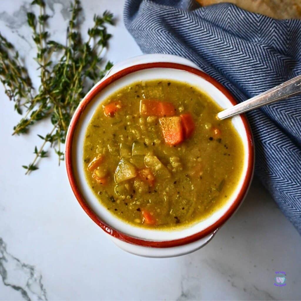a round bowl with a spoon containing slow cooker vegan pea soup