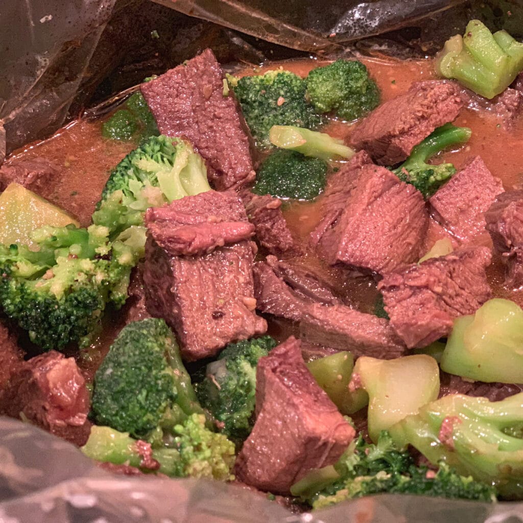 View of cooked beef with veggies in crockpot