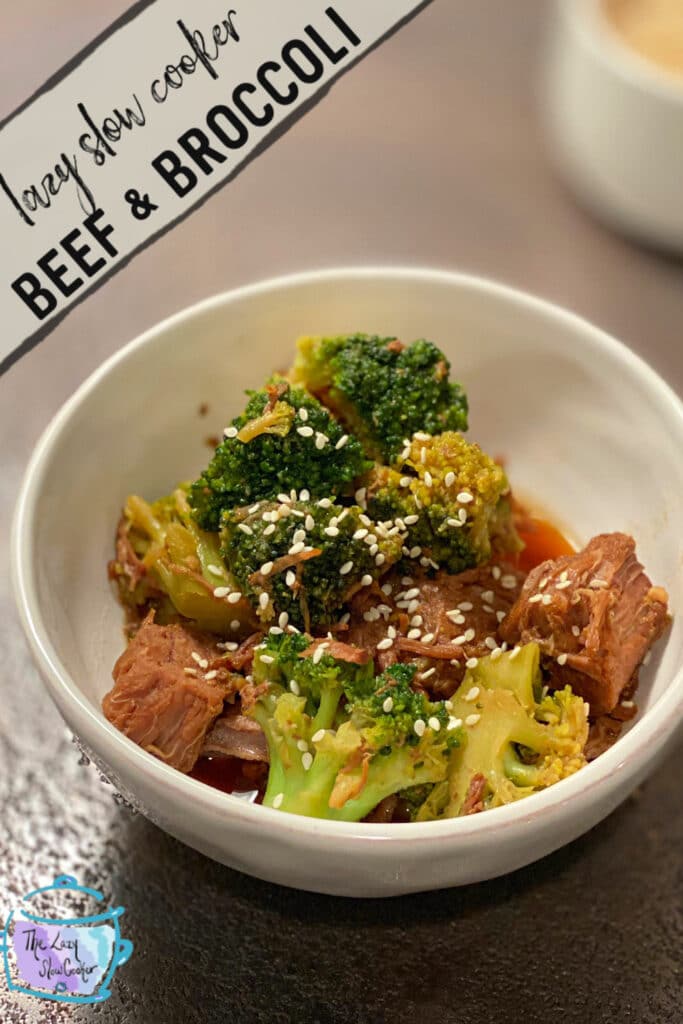 Beef and broccoli made i a slow cooker showed in a white bowl with sesame seeds