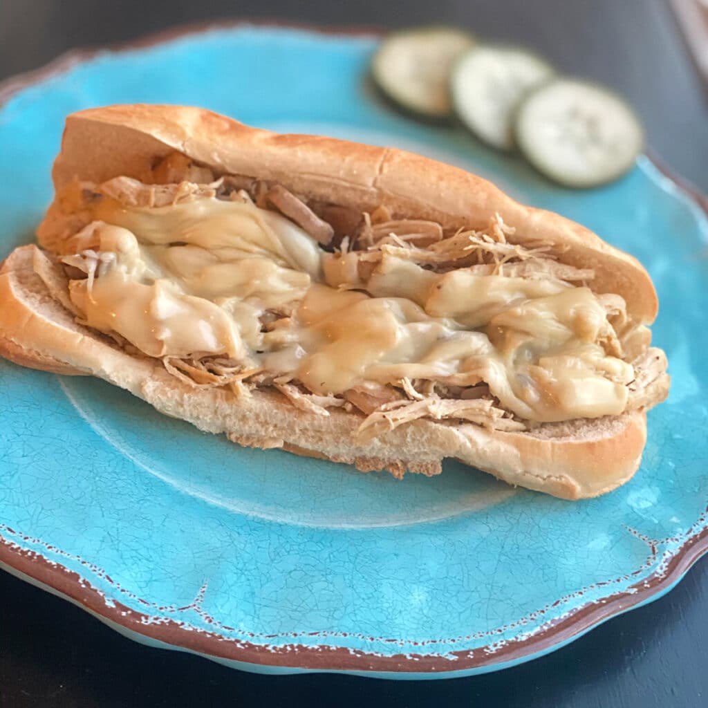 close up of hoagie roll, chicken mixture and melted cheese