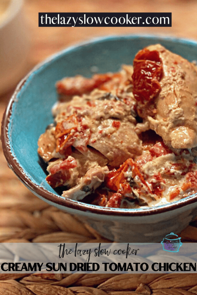 a bowl filled with chicken and sun dried tomatoes in a creamy sauce after cooking in a slow cooker
