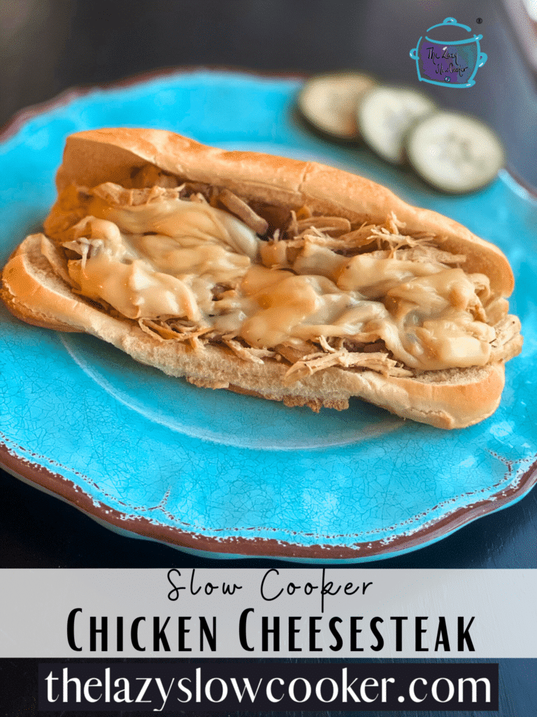 a cheesesteak sandwich with melted cheese on a blue plate.