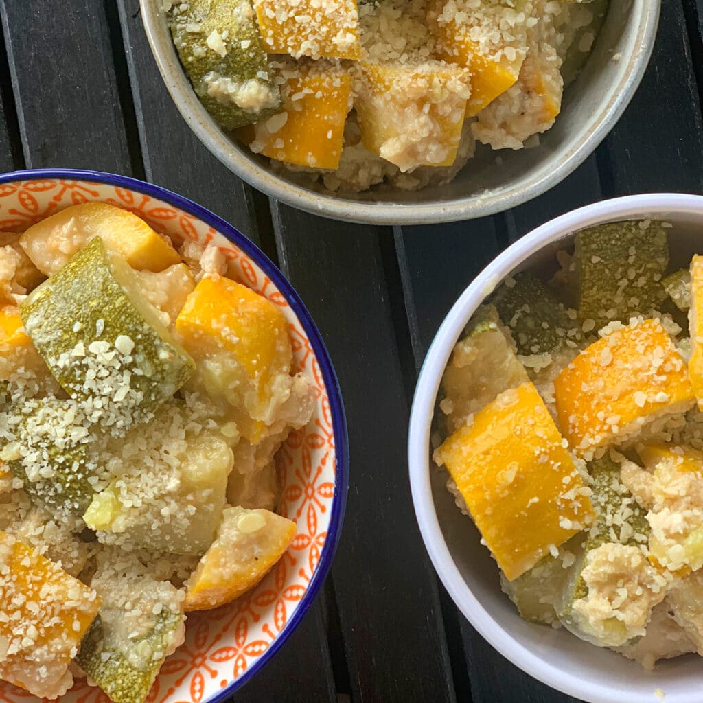 top view close up of three bowls of summer slow cooker zucchini squash parmesan. 