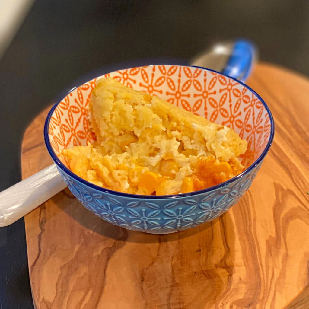 side view of sweet corn spoonbread in a round bowl