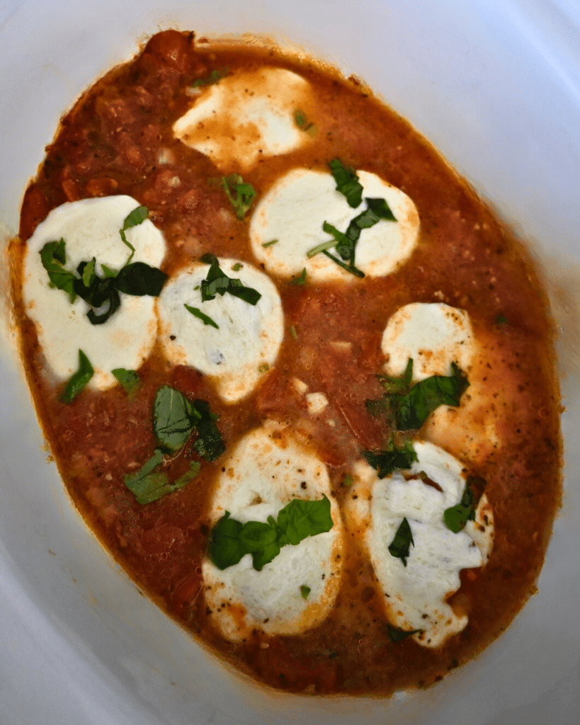 Finished caprese chicken in a slow cooker ready to serve