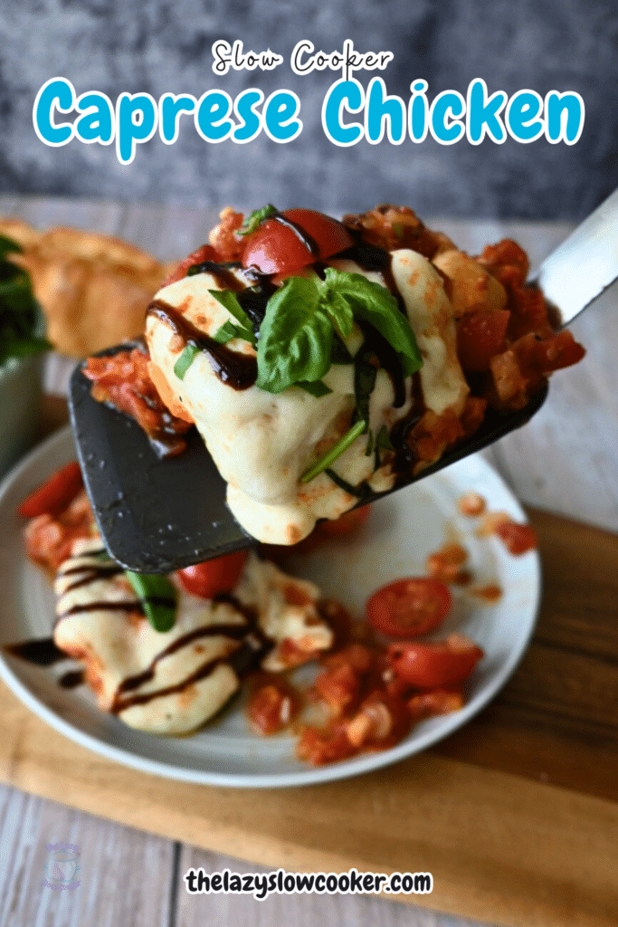 slow cooker Caprese chicken on a spatula over a plate of the same