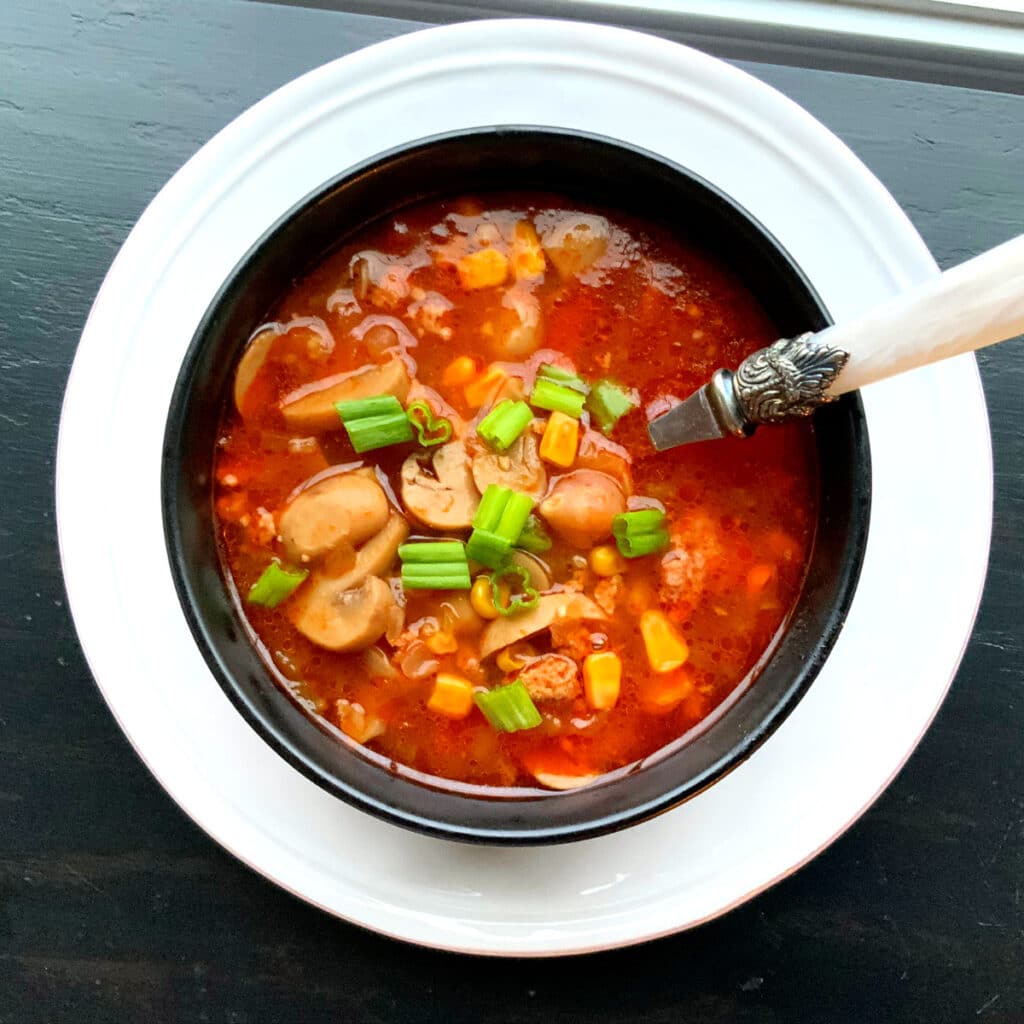 Looking down on a black round bowl filled with turkey burger soup