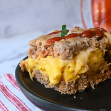 a side view of a slice of mac and cheese stuffed slow cooker meatloaf