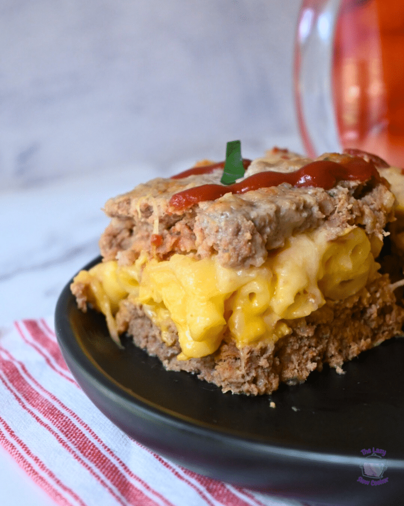 a side view of a slice of mac and cheese stuffed slow cooker meatloaf