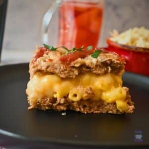 a side view of a slice of mac and cheese stuffed slow cooker meatloaf