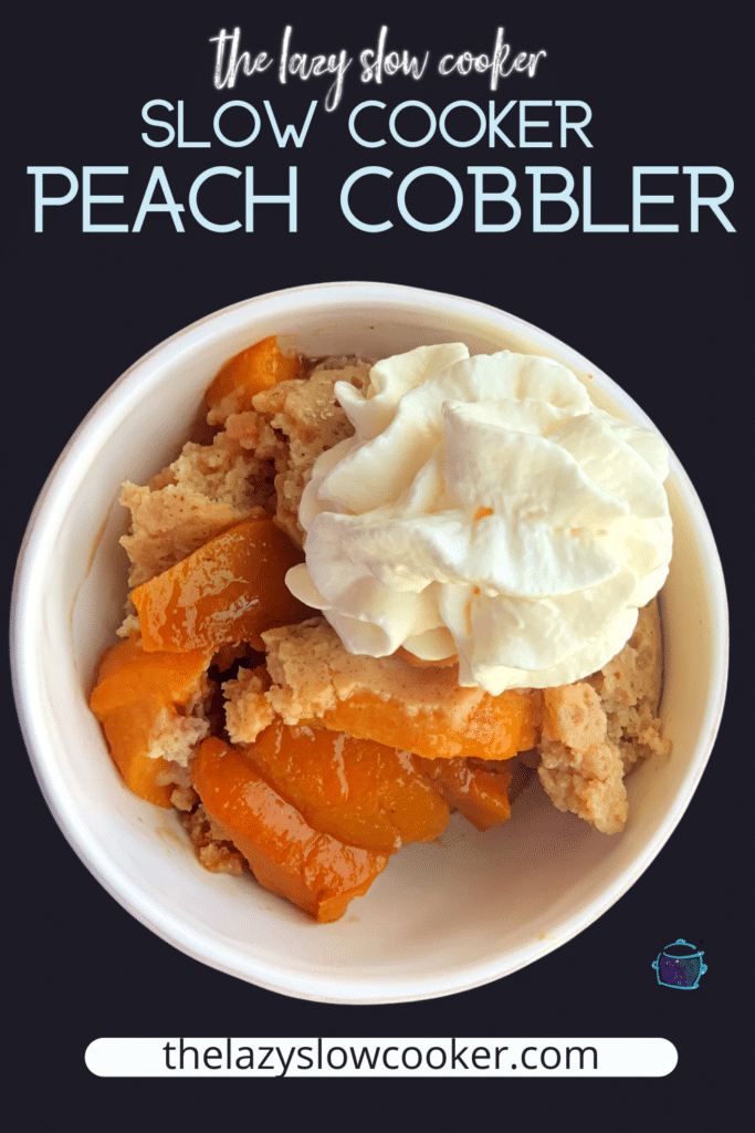 Slow cooker peach cobbler in a bowl topped with whipped cream