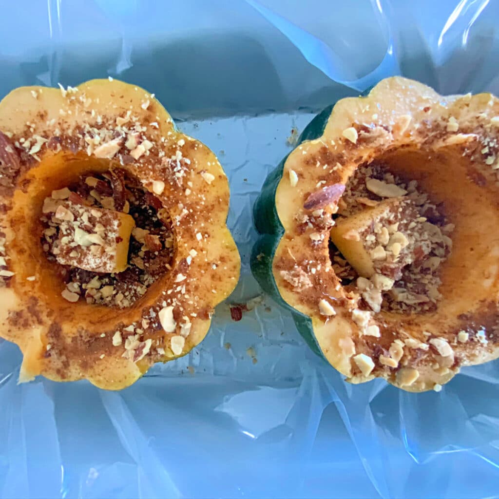 Two halves of squash in crockpot before cooking