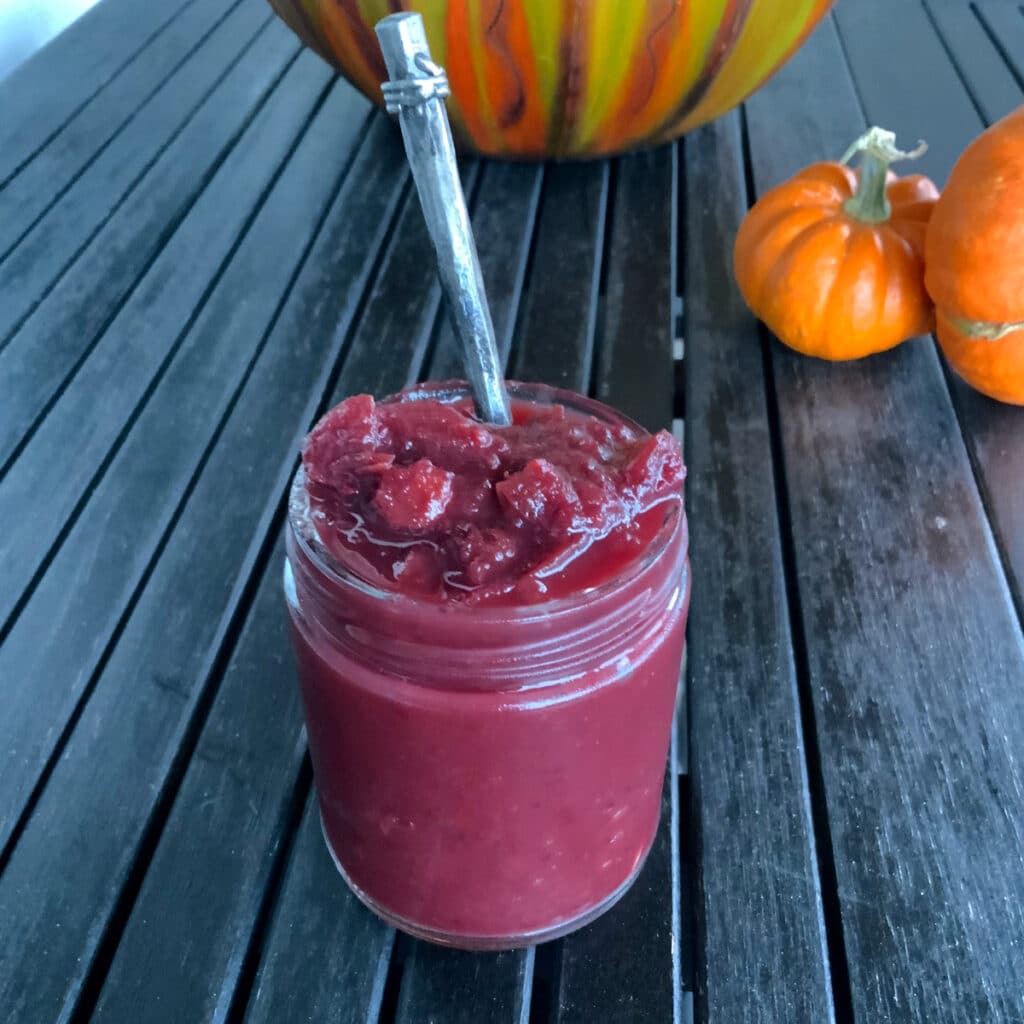 close in a glass jar with a spoon on a black table