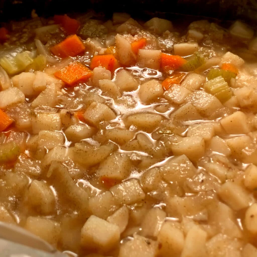 diced potatoes and other soup ingredients in slow cooker after cooking but before blending