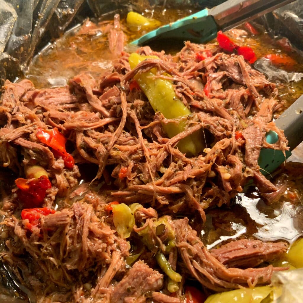 cooked roast beef in slow cooker ready to plate