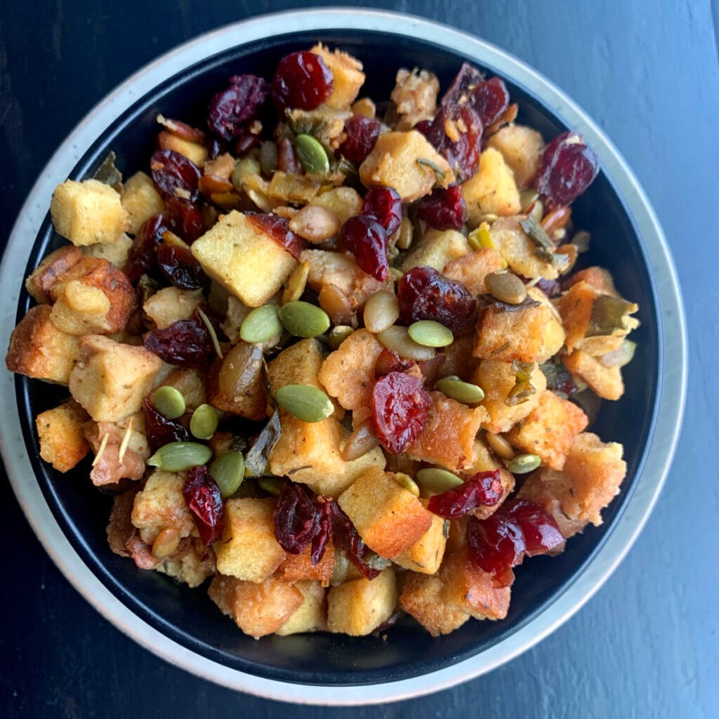 looking down on a bowl of cranberry and pumpkin seed stuffing ready to be served