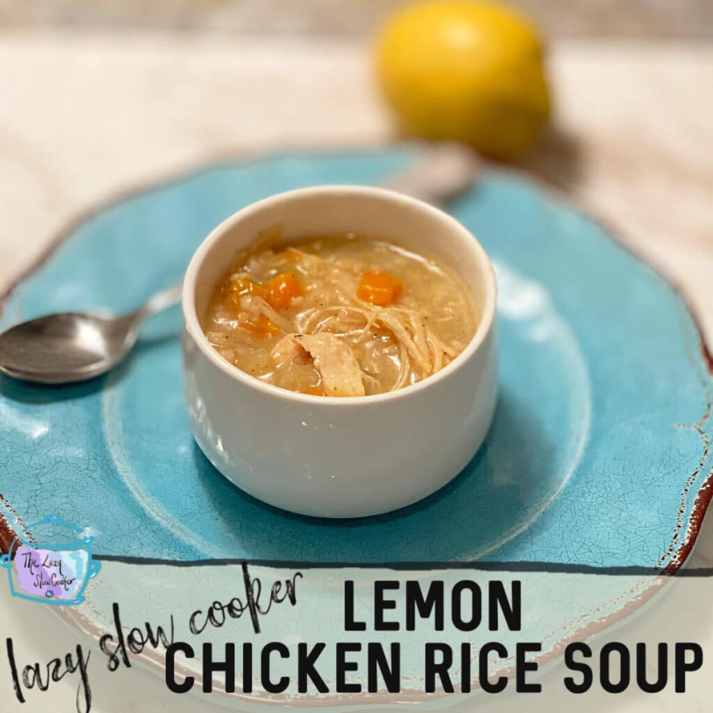 skinny slow cooker recipe of round bowl of a thick looking stew with carrots and chicken pieces. On a turquoise plate with a spoon and a blurred lemon in the background