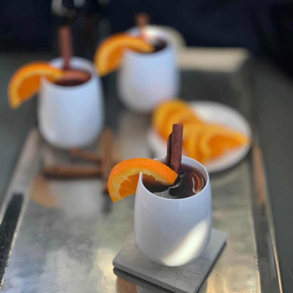 mulled wine in white cups on a silver tray